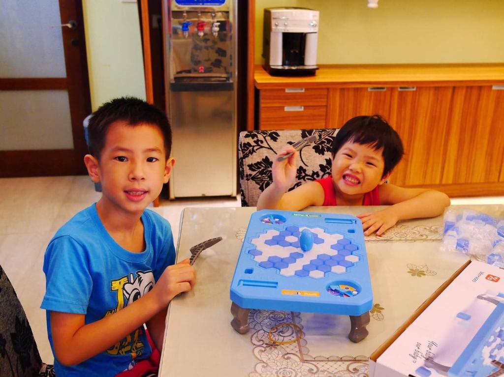 two young boys sitting at a table with a toy at Jane Castle in Wujie