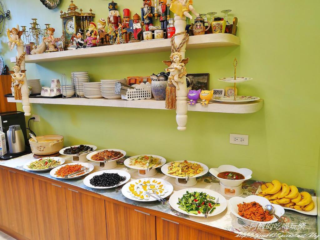 a buffet with plates of food on a counter at Jane Castle in Wujie