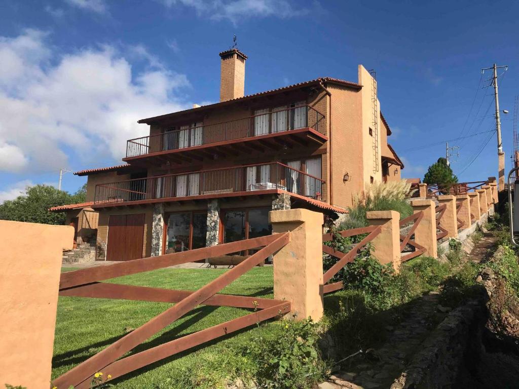 a house with a fence in front of it at Luxurious Cabin Retreat in Tapalpa 4 Bedrooms 6 Bathrooms in Tapalpa