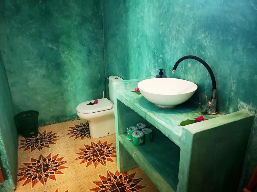 a bathroom with a sink and a toilet at Demani Lodge Zanzibar in Paje
