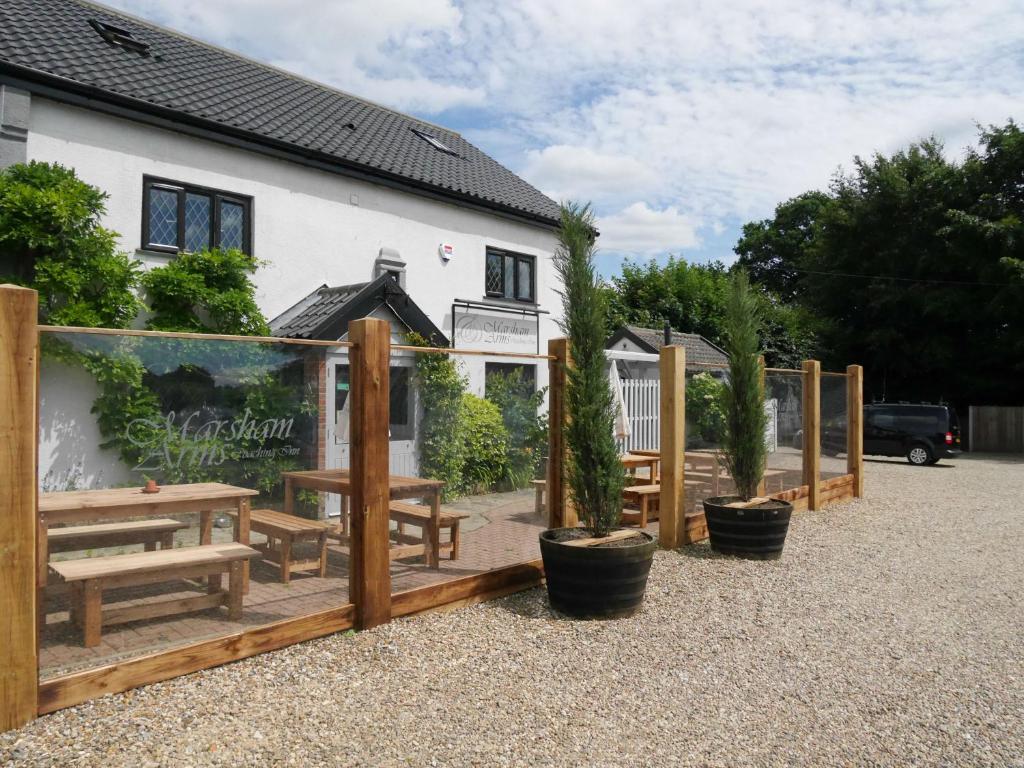 a group of benches and tables in front of a building at Marsham Arms Inn in Hevingham