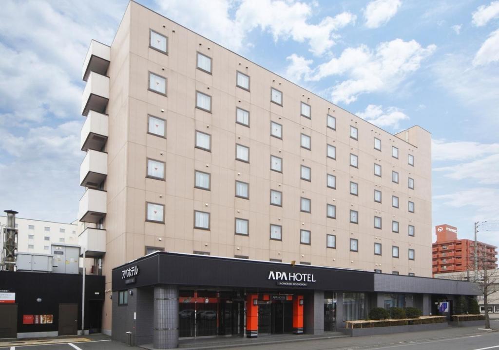 a large building on a city street with a building at APA Hotel Aomorieki-Kenchodori in Aomori