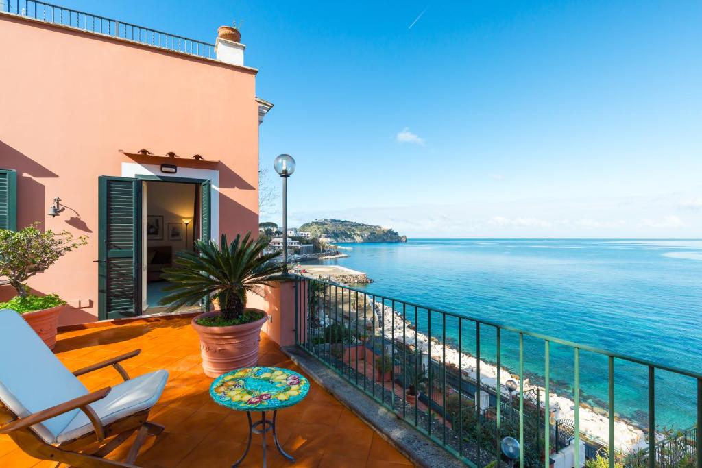 a balcony with a view of the ocean at Terrazza Morgera by Napoliapartments in Ischia