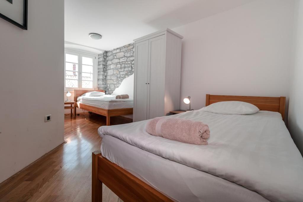 a bedroom with a bed with a pink towel on it at Apartments Artemus Music in Piran
