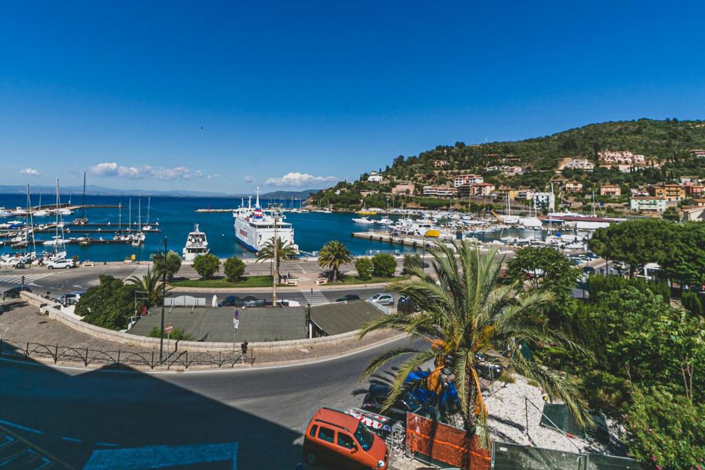 a view of a marina with boats in the water at Hotel Alfiero in Porto Santo Stefano
