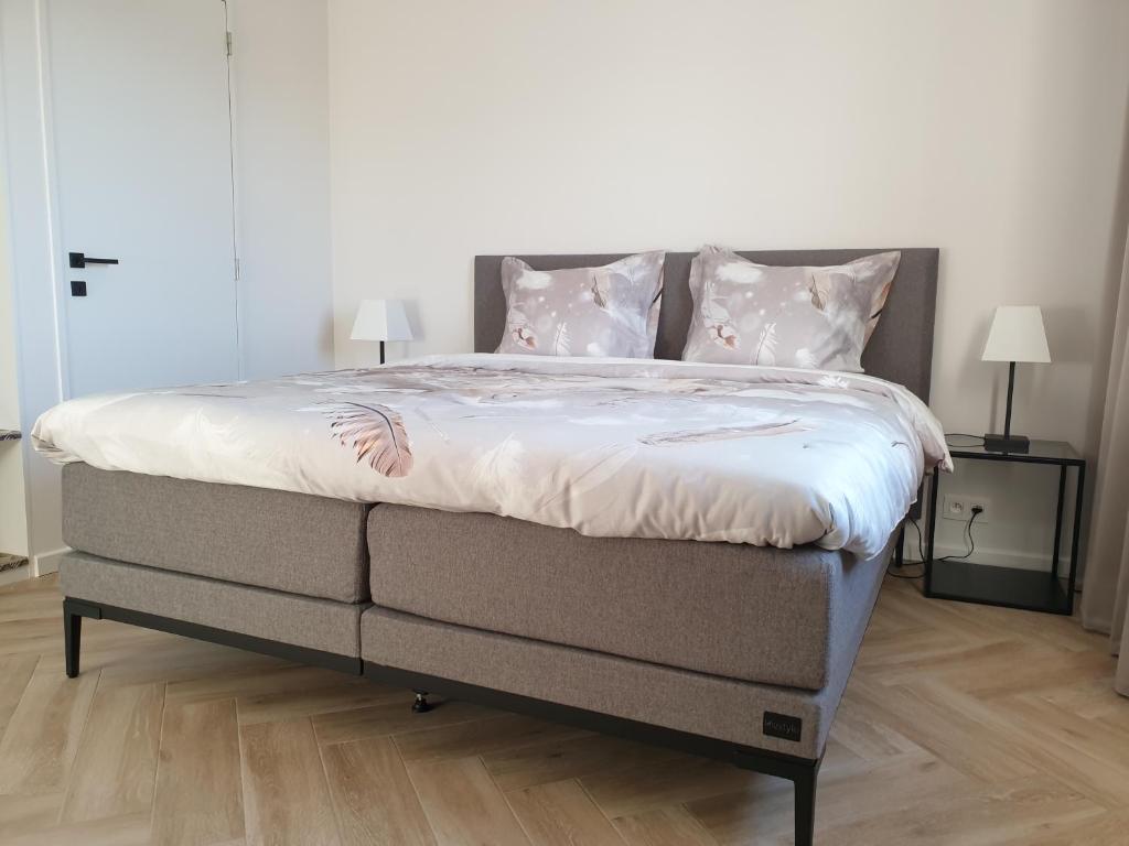 Postel nebo postele na pokoji v ubytování Snooze