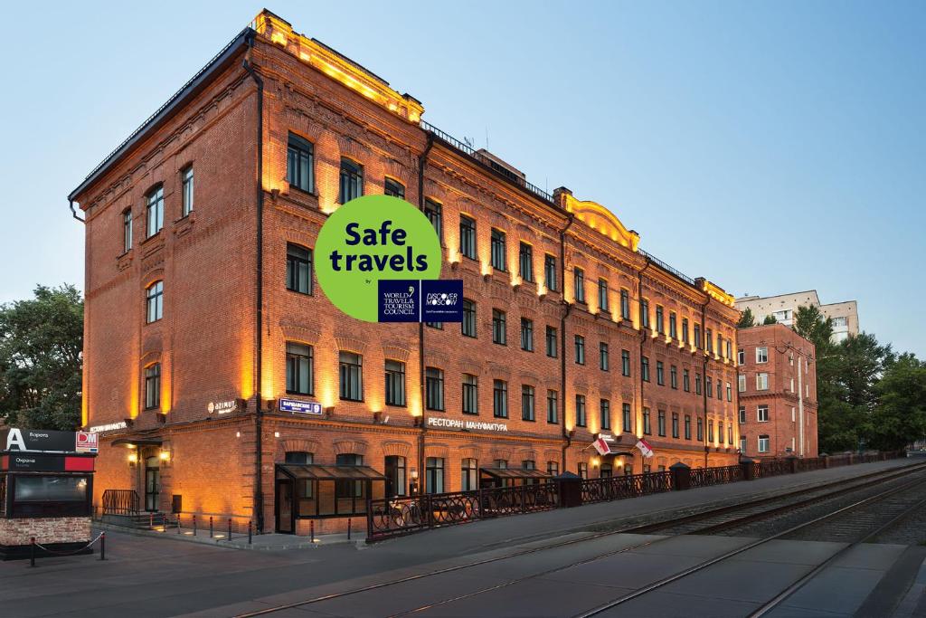 a large brick building with a sale travels sign on it at AZIMUT Hotel Tulskaya Moscow in Moscow