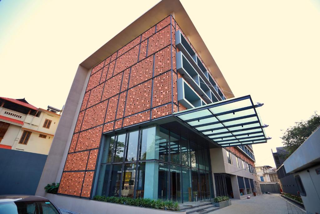 a red brick building with a lot of windows at E.05 City Inn in Alwaye