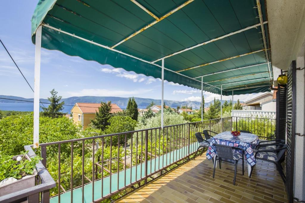 eine Terrasse mit einem Tisch und Stühlen auf dem Balkon in der Unterkunft Apartment Vili in Pinezici