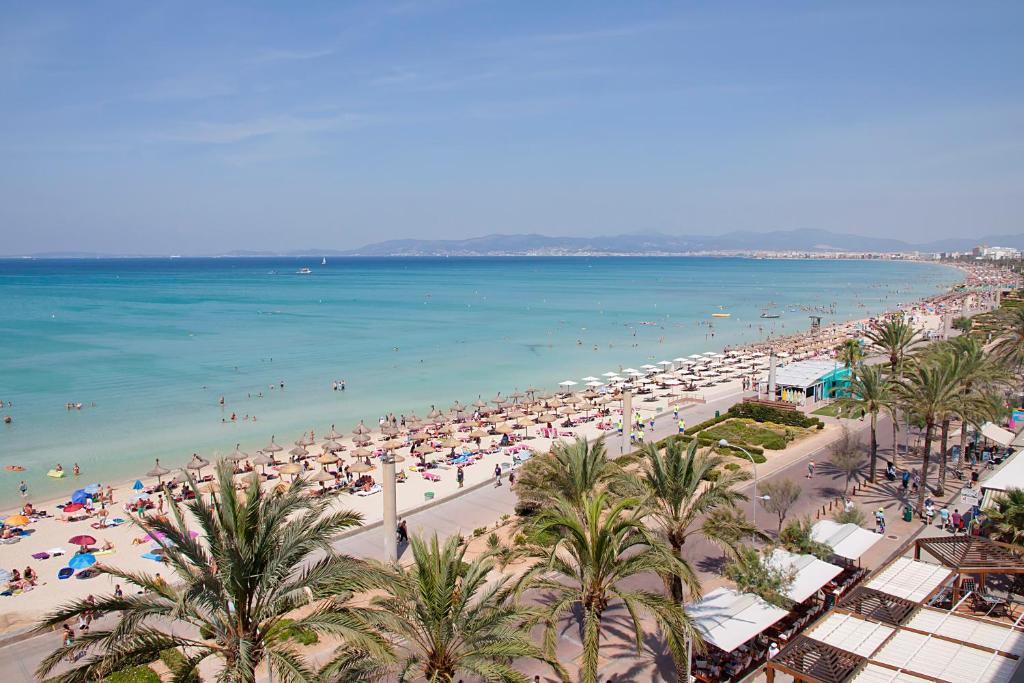 a beach with a lot of people and the ocean at AYA Seahotel - Adults Only in Playa de Palma