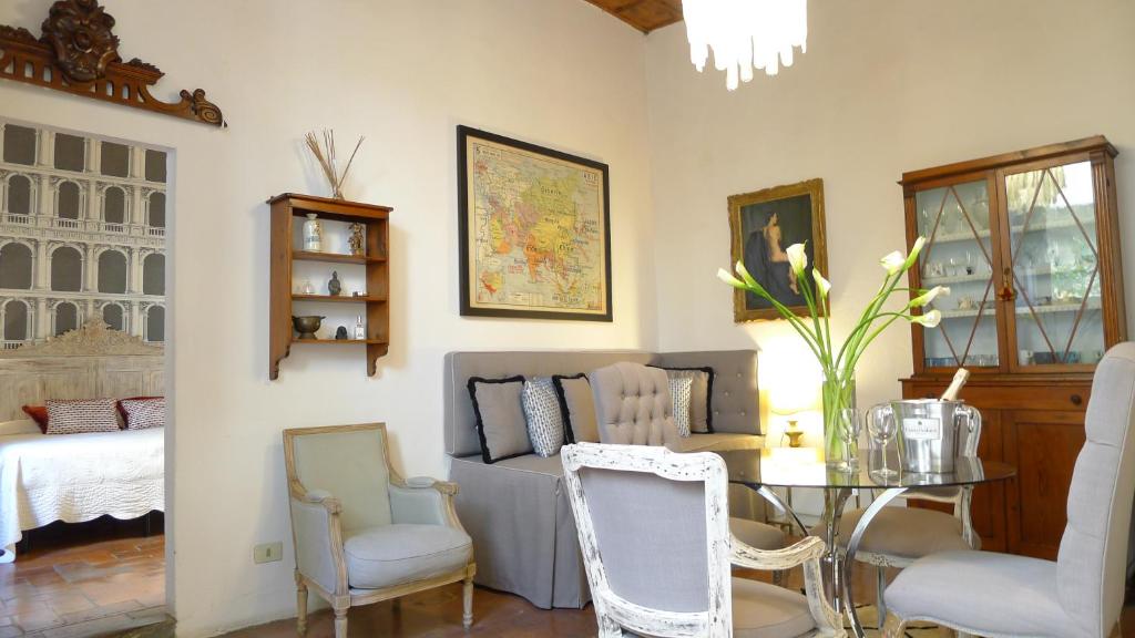 a living room with a table and chairs and a bed at Sprone Apartment in Florence