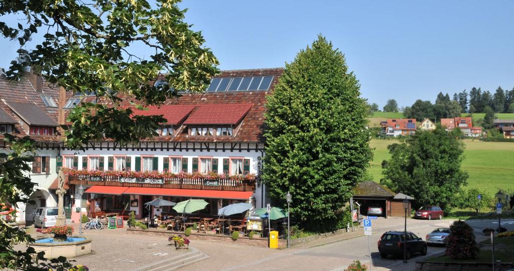 a building with a restaurant on the side of a street at Hotel Hirschen in Sankt Peter
