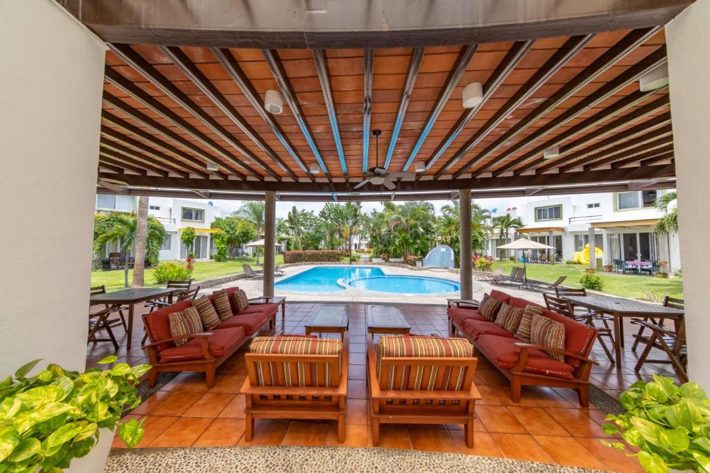 a patio with chairs and a table and a pool at Casa LUNA in Mezcales