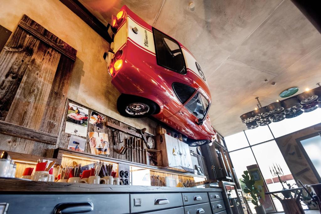 a car hanging from the ceiling of a garage at Motorworld Inn in Warthausen