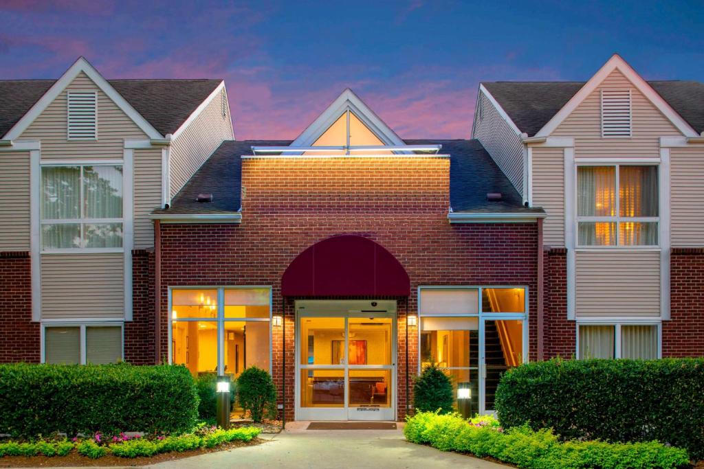 a red brick house with a sunset in the background at Sonesta ES Suites Nashville Brentwood in Brentwood