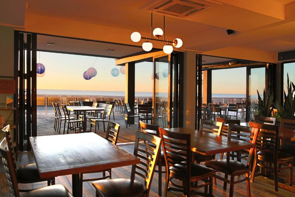 a restaurant with tables and chairs and a view of the ocean at Quality Inn Boardwalk in Ocean City