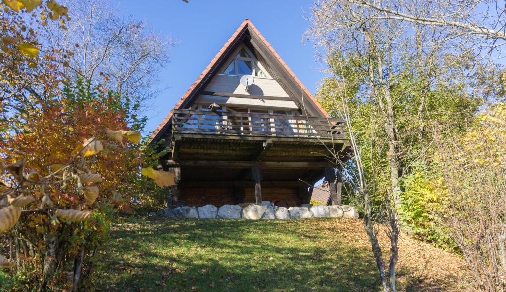 a log cabin with a thatched roof at Haus 4-Jahreszeiten in Siegsdorf