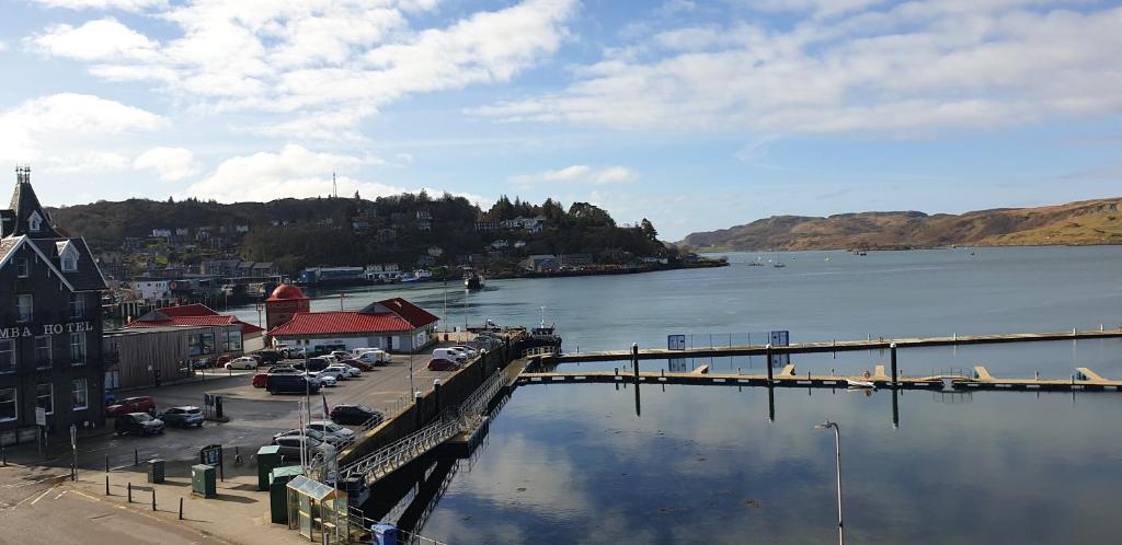 a large body of water with a town and a dock at The Editor's Choice, Oban seafront apartment in Oban