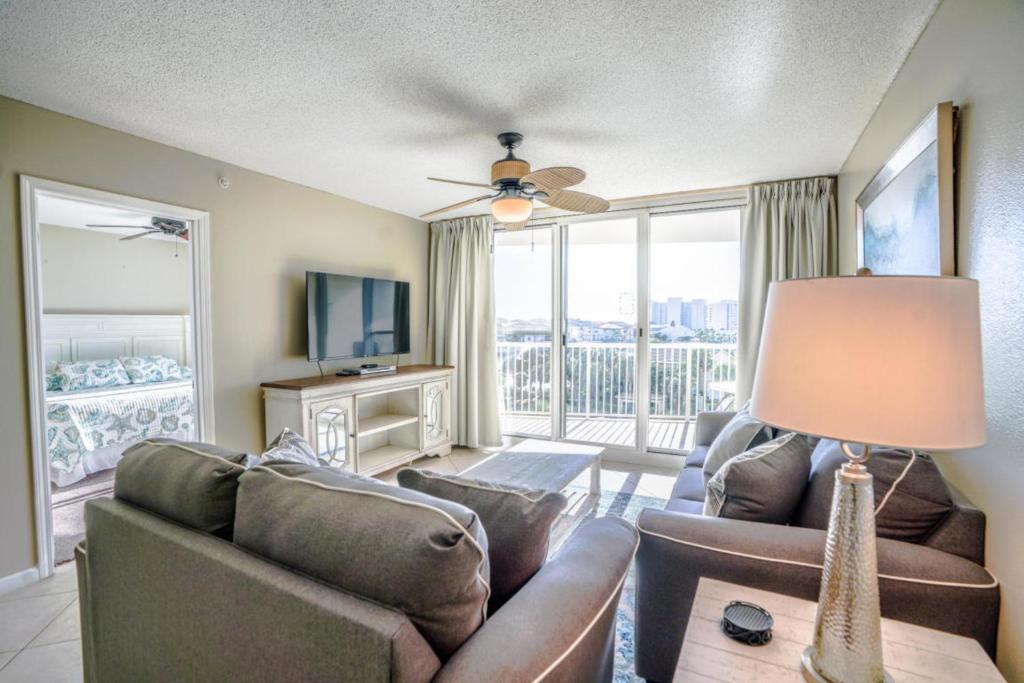 a living room with a couch and a television at The Terrace at Pelican Beach 302 in Destin