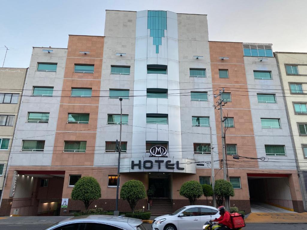 a hotel with cars parked in front of it at HOTEL MARIA RICO in Mexico City