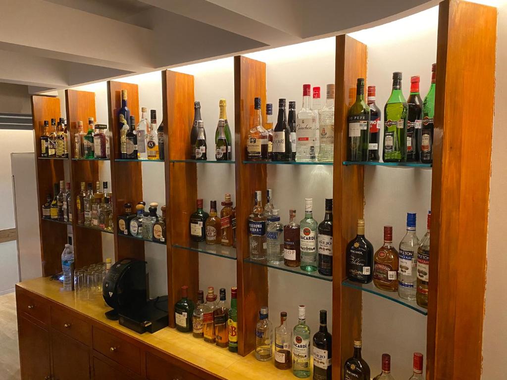A built-in bar display stocked with a broad selection of spirits and liqueurs.