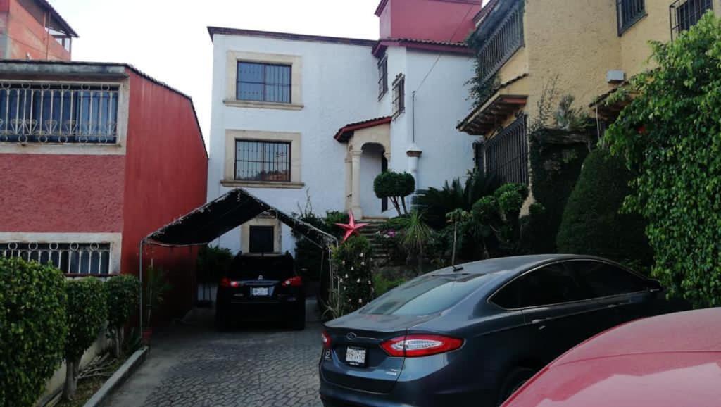 a car parked in front of a house at Casa Guelaguetza By Rotamundos in Oaxaca City