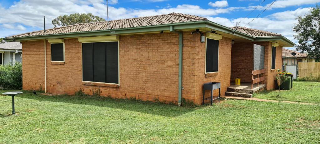 a small brick house with a grass yard at Kubo House in Dubbo