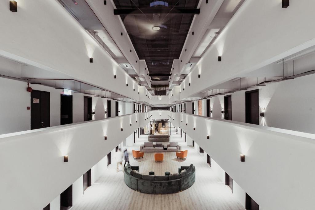 A bright multi-level interior corridor overlooking a central lounge.