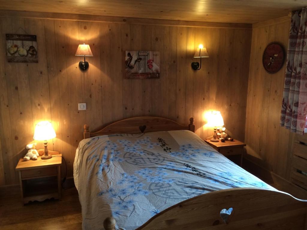 ムジェーヴにあるChambre d'hôte de l'Auguilleのベッドルーム1室(ベッド1台、ランプ2つ、テーブル2台付)