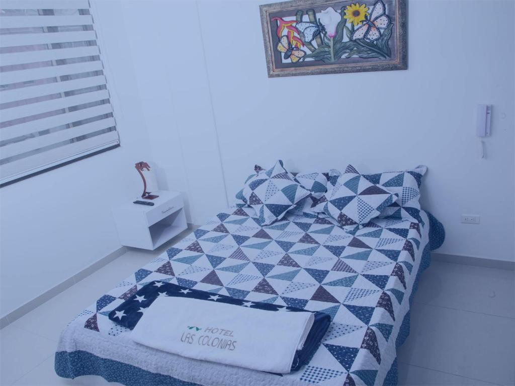 Postel nebo postele na pokoji v ubytování Hotel Las Colonias