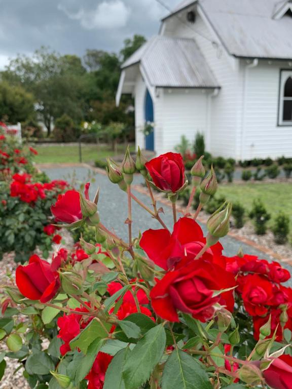 a bouquet of red roses in front of a house at The Church at Barrington in Barrington