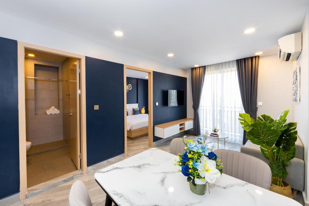 a living room with a dining table and a bedroom at SS Hotel & Residence in Sihanoukville