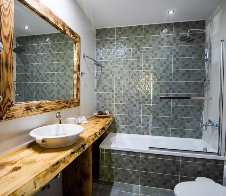 a bathroom with a sink and a shower and a tub at Archontiko Liamas in Stavros