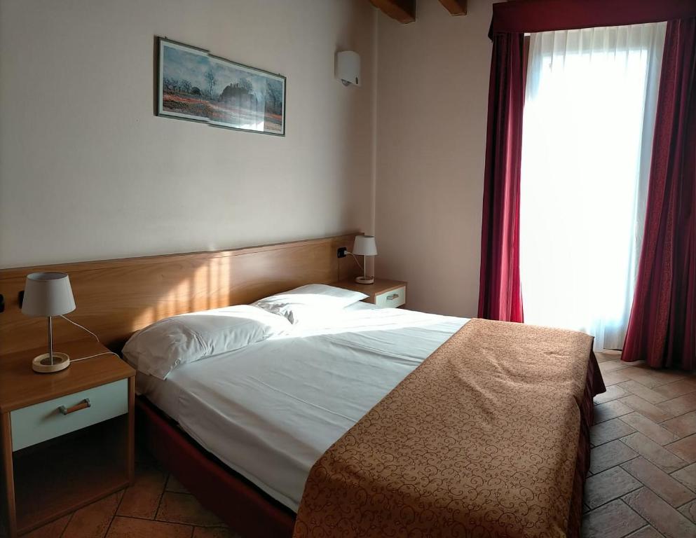 Postel nebo postele na pokoji v ubytování Hotel Agli Ulivi