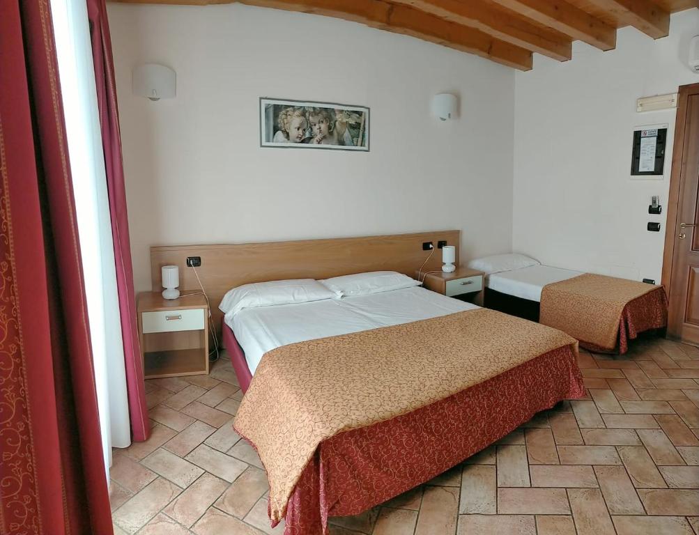 Postel nebo postele na pokoji v ubytování Hotel Agli Ulivi