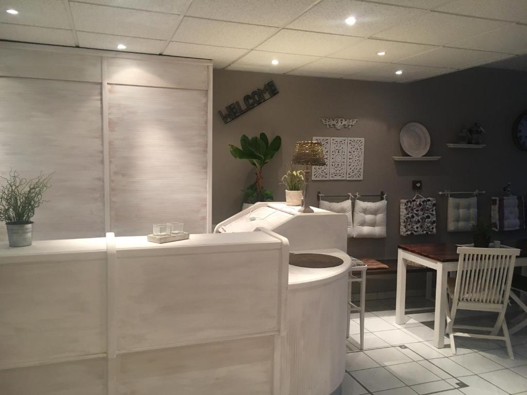 a bathroom with a shower and a white counter at Pension Claudia in Vösendorf