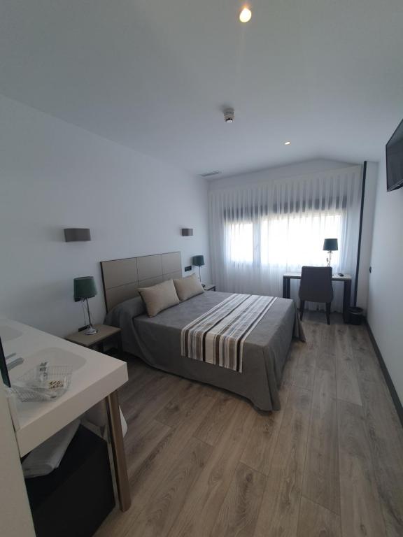 Posteľ alebo postele v izbe v ubytovaní HOTEL IBERUM