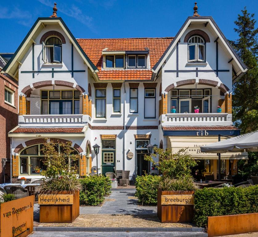 a large white house with a red roof at Hotel Breeburg in Bergen