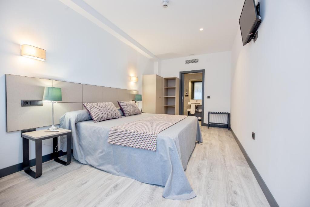 Posteľ alebo postele v izbe v ubytovaní HOTEL IBERUM