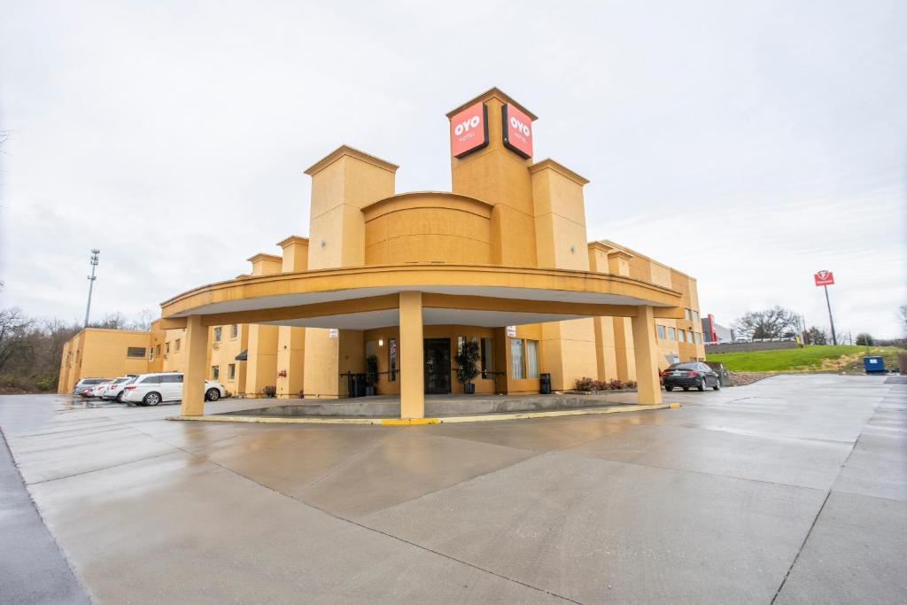 a building with a clock tower in a parking lot at OYO Hotel Knoxville TN Cedar Bluff I-40 in Knoxville