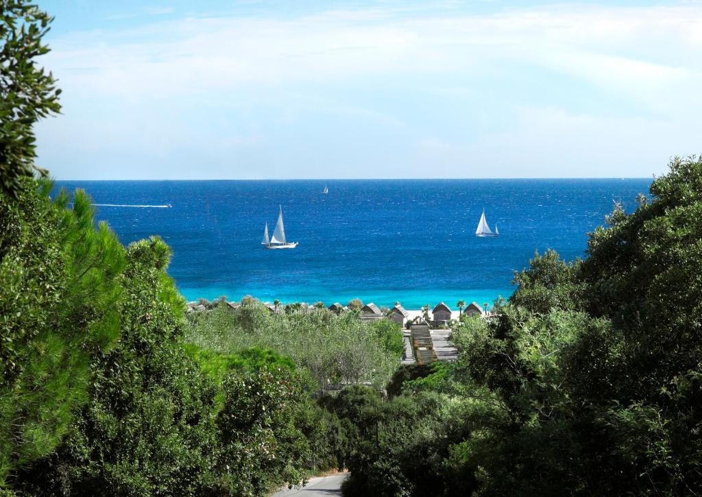 a view of the ocean with two sailboats in the water at Kon Tiki in Saint-Tropez