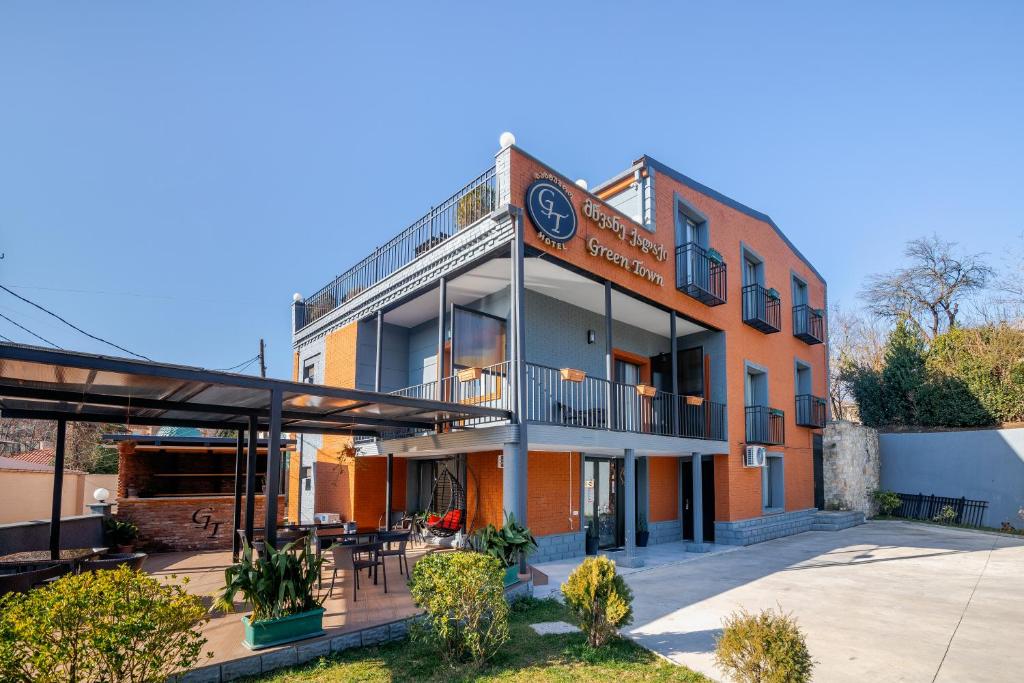 an exterior view of a building with a patio at Hotel Green Town in Kutaisi