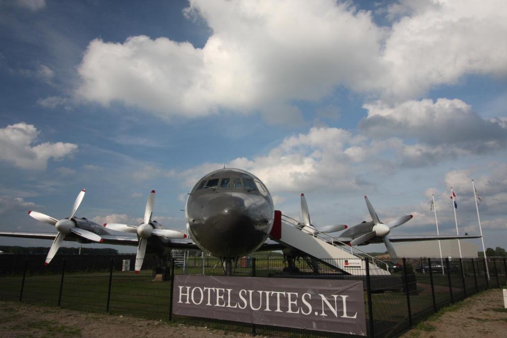 an airplane is sitting on top of a sign at Vliegtuigsuite Teuge in Teuge