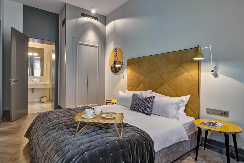 a hotel room with a bed with a table on it at H15 Boutique Hotel, Warsaw, a Member of Design Hotels in Warsaw