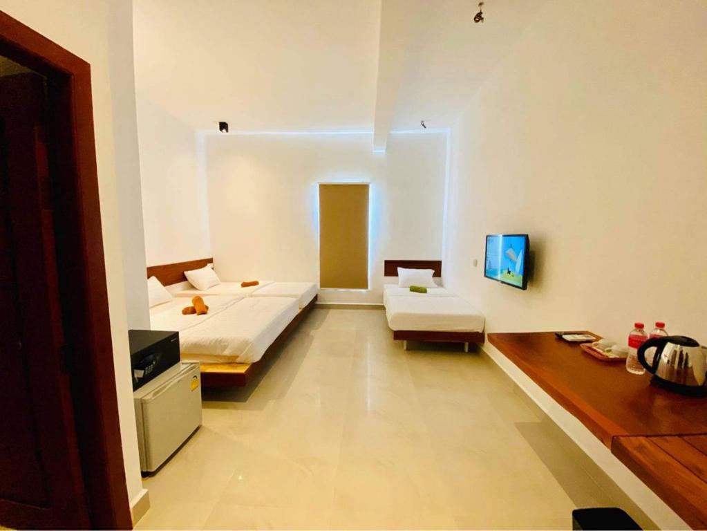 Postel nebo postele na pokoji v ubytování Onederz Kampot