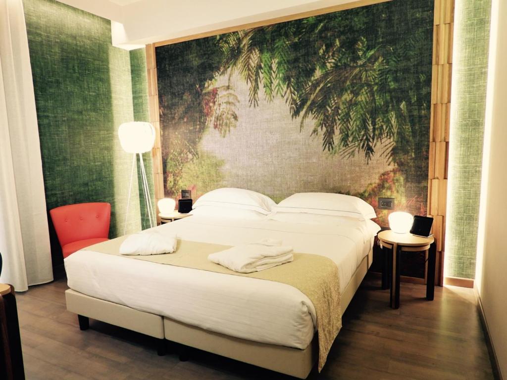 Postel nebo postele na pokoji v ubytování Hotel Firenze