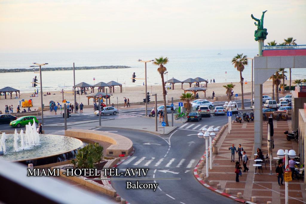 a view of a beach with people walking on the street at Miami Beach Hotel Tel Aviv in Tel Aviv