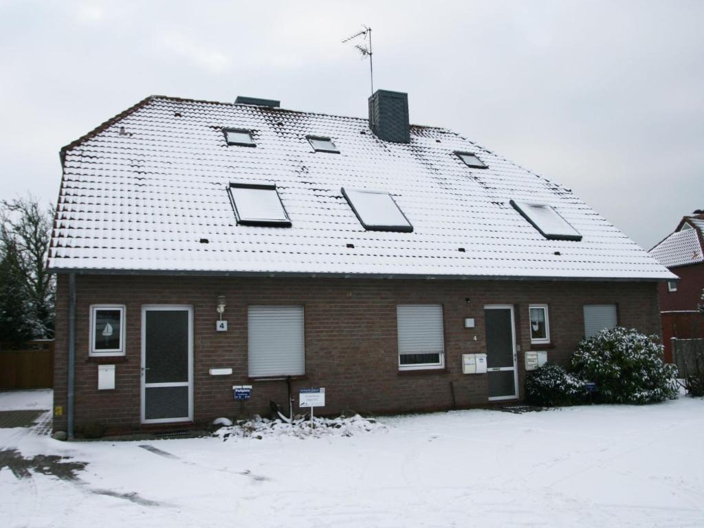 een huis met een dak bedekt met sneeuw bij Apartment Kluntje by Interhome in Norddeich