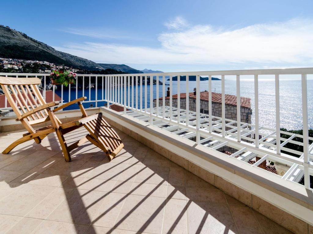 a balcony with a bench and a view of the water at Apartment Paco in Dubrovnik
