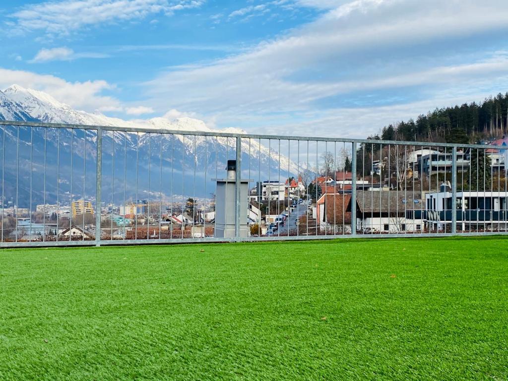 a green field with a view of a city at Exklusive Penthousewohnung mit Tesla-Wallbox in Innsbruck in Innsbruck